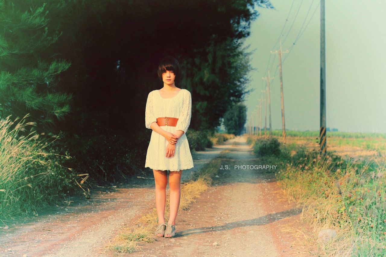 full length, lifestyles, casual clothing, standing, leisure activity, front view, rear view, tree, young adult, walking, young women, the way forward, person, road, dress, day, outdoors, umbrella