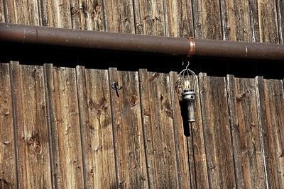 Close-up of padlock hanging on metal