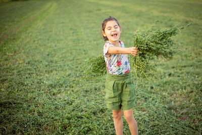 Portrait of boy standing on field