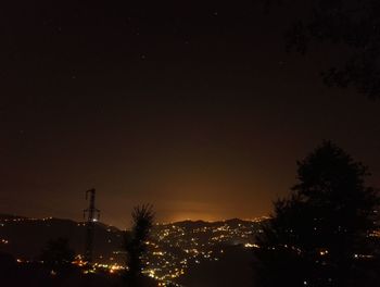 Low angle view of silhouette trees against sky at night