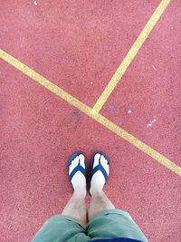 Low section of person standing on tiled floor