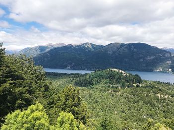 Scenic view of mountains and lake against cloudy sky