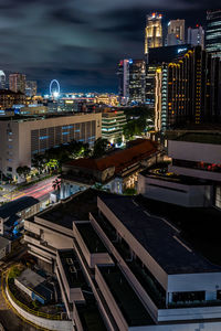 High angle view of illuminated buildings in city at night