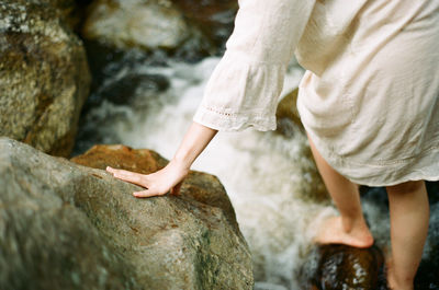 Low section of woman on rock