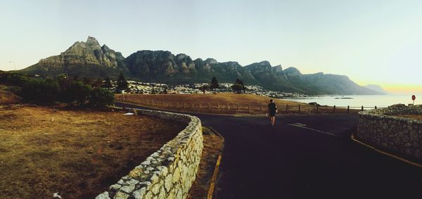 Panoramic view of river and mountains against clear sky