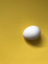 Close-up of apple against yellow background