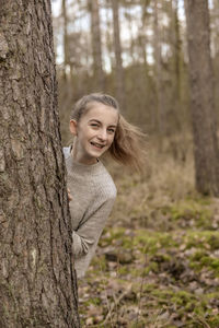 Portrait of a smiling young woman in forest