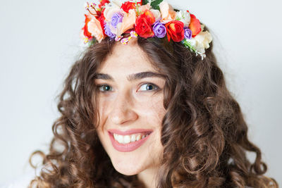 Close-up portrait of smiling woman wearing floral wreath