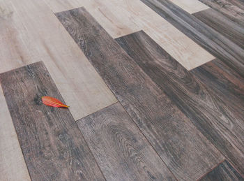 High angle view of arrow symbol on hardwood floor