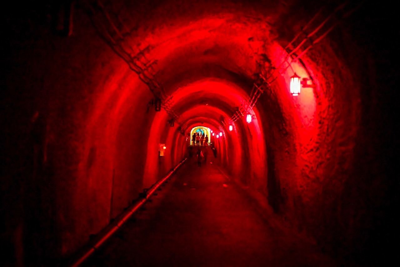 VIEW OF EMPTY ILLUMINATED TUNNEL