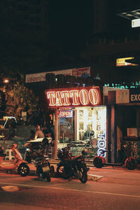 View of illuminated city street at night