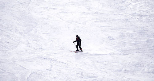 Full length of woman walking on snowcapped mountain