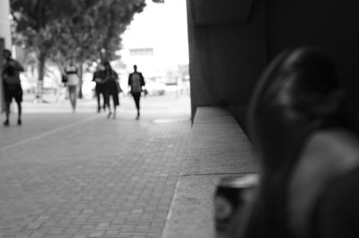 Rear view of people walking on street