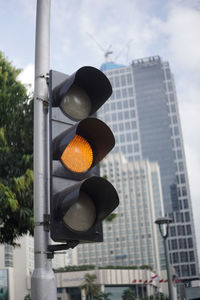 Low angle view of road signal against sky