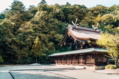 Temple by building against sky