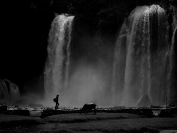 Panoramic view of waterfall against sky at night