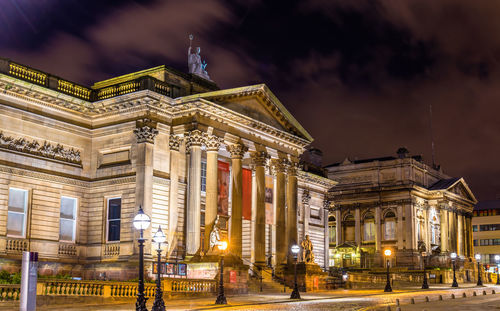 Low angle view of illuminated building against sky at night