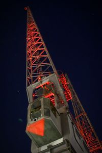 Low angle view of illuminated tower against sky at night