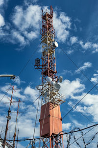 Low angle view of communications tower against sky