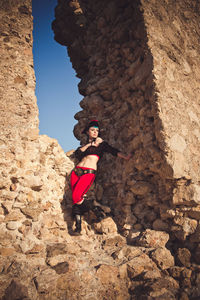 Portrait of a pirate woman at the beach. in anticipation of a pirate ship