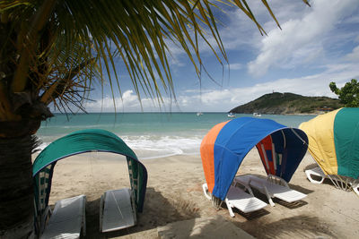 Sunshades and sun loungers on beach