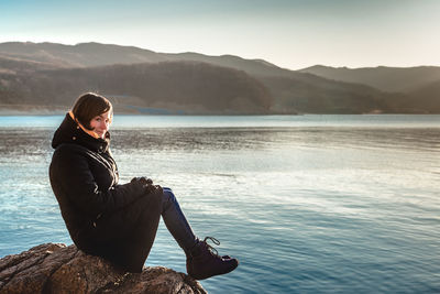 Young woman looking at lake against mountain range and japan sea