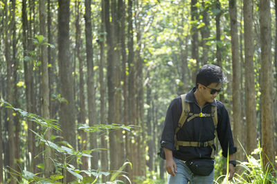 Young man standing in forest