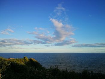 Scenic view of sea against blue sky