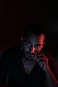 Portrait of young man in darkroom