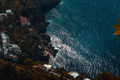 High angle view of buildings by sea