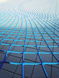 Full frame shot of blue net on tiled floor