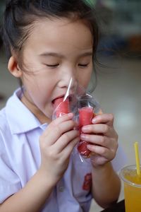 Close-up of girl eating fruit 