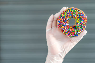 Close-up of hand holding donut