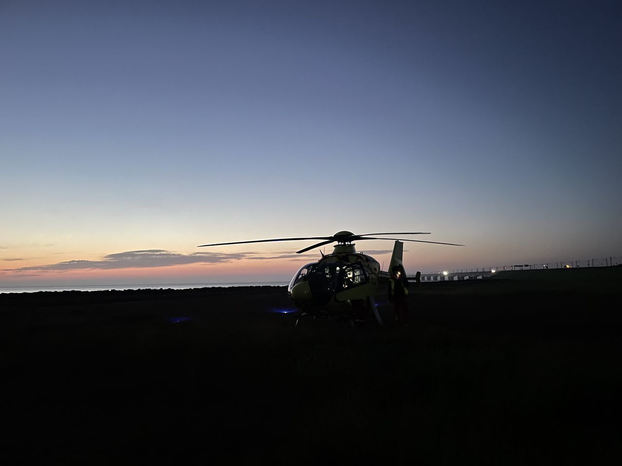 SILHOUETTE CRANES AGAINST CLEAR SKY DURING SUNSET