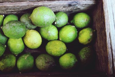 High angle view of lemons in wooden crate