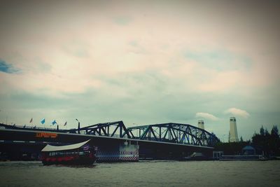 Bridge over sea against sky in city