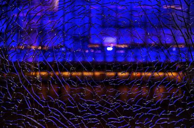 Full frame shot of illuminated lights against blue sky at night