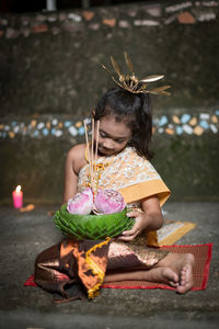 High angle view of young woman sitting on table