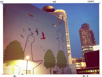 Low angle view of illuminated building against sky