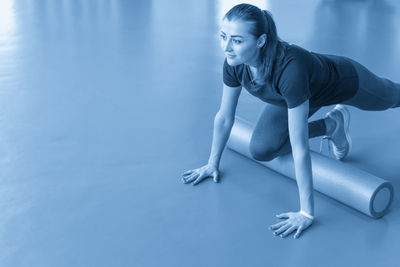 Side view of woman exercising in gym