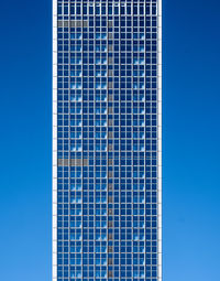 Low angle view of modern building against blue sky