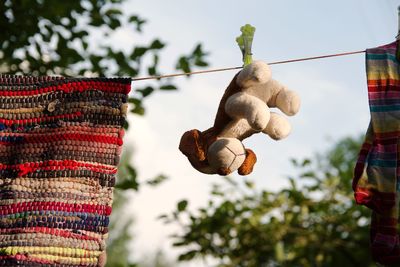 Low angle view of decoration hanging on tree against sky