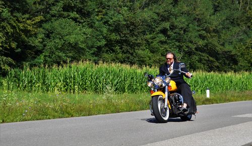 Man riding harley davidson motorcycle on road