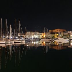 Sailboats in marina at night