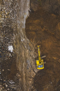 High angle view of sign on rock by lake