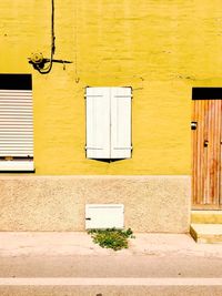 Yellow window on wall