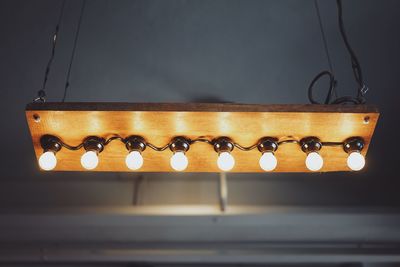 Close-up of illuminated lighting equipment hanging on table