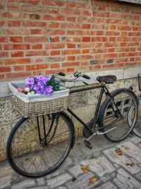 Bicycle in basket on brick wall