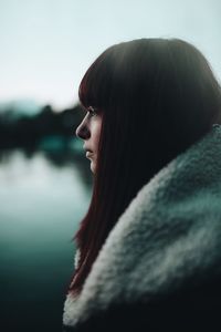 Close-up portrait of young woman looking away