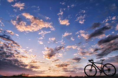 Low angle view of silhouette bicycle against sky during sunset